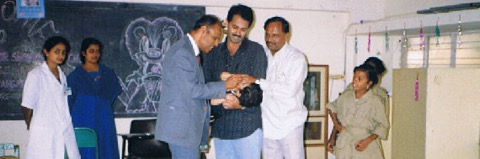 Dr. Lakshman vaccinating a child